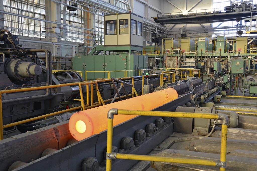 A 155mm howitzer tube moves to a rotary forge from an arsenal furnace where it was heated to nearly 2,000 degrees. After an approximate 15 minutes of forging, the tube will have the near-finished shape of a howitzer tube.