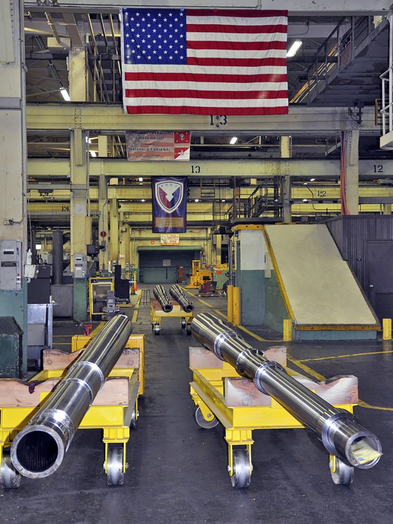 A 155mm howitzer tube and a 120mm Abrams Tank tube await their next machining operation